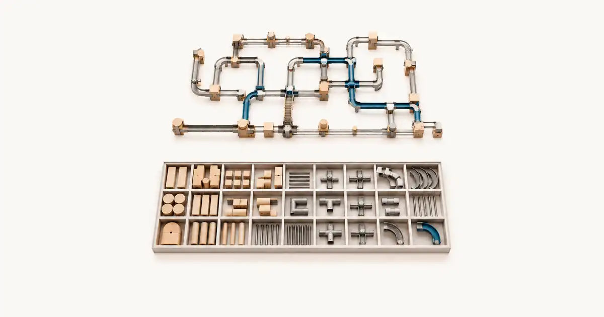 Red modular de tuberías armada sobre una bandeja con piezas clasificadas por tipo.